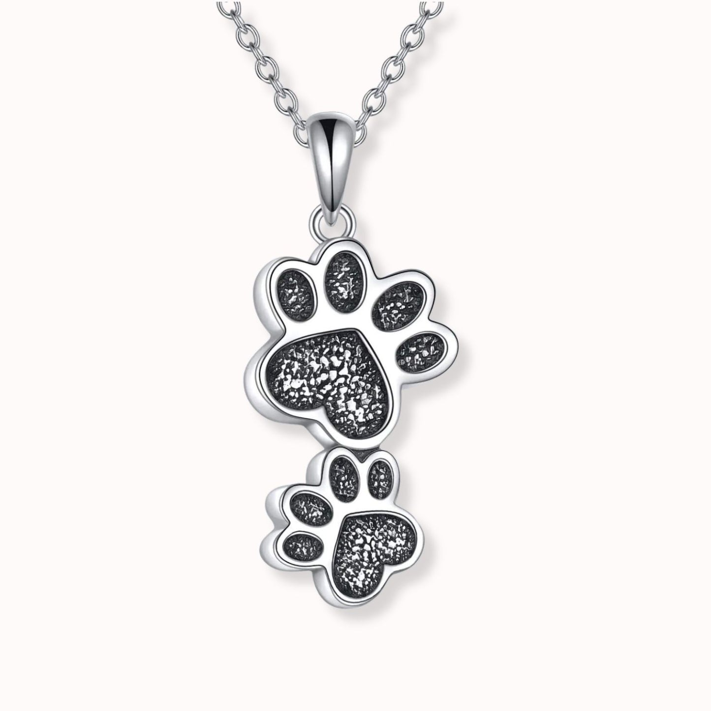 Colgante de plata para guardar cenizas, con forma de 2 huellas de mascota colgantes, con el interior negro y una fina cadena