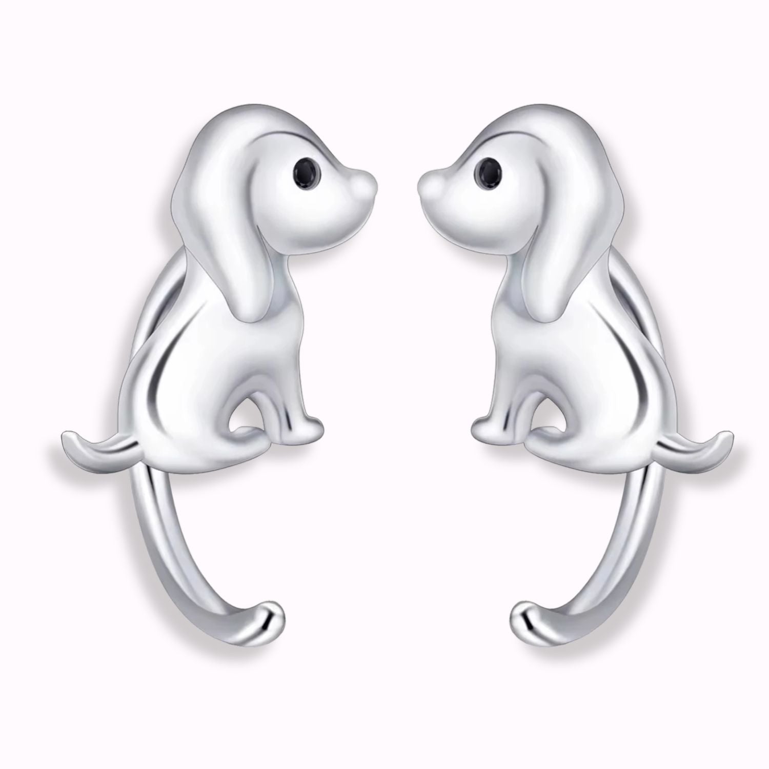 Pendientes de plata con forma de perritos con la cola larga, sobre fondo blanco de el corte inglés